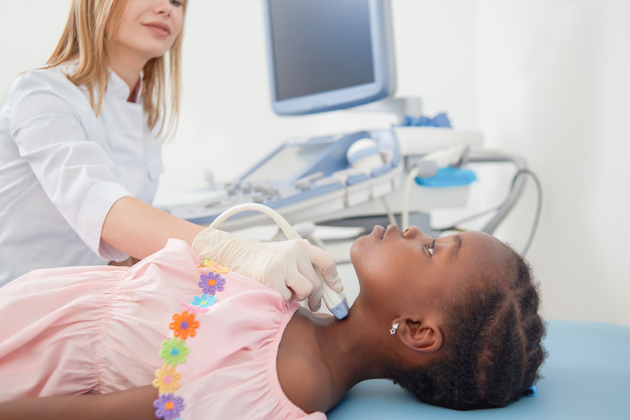 Child lying when doctor scanning her neck