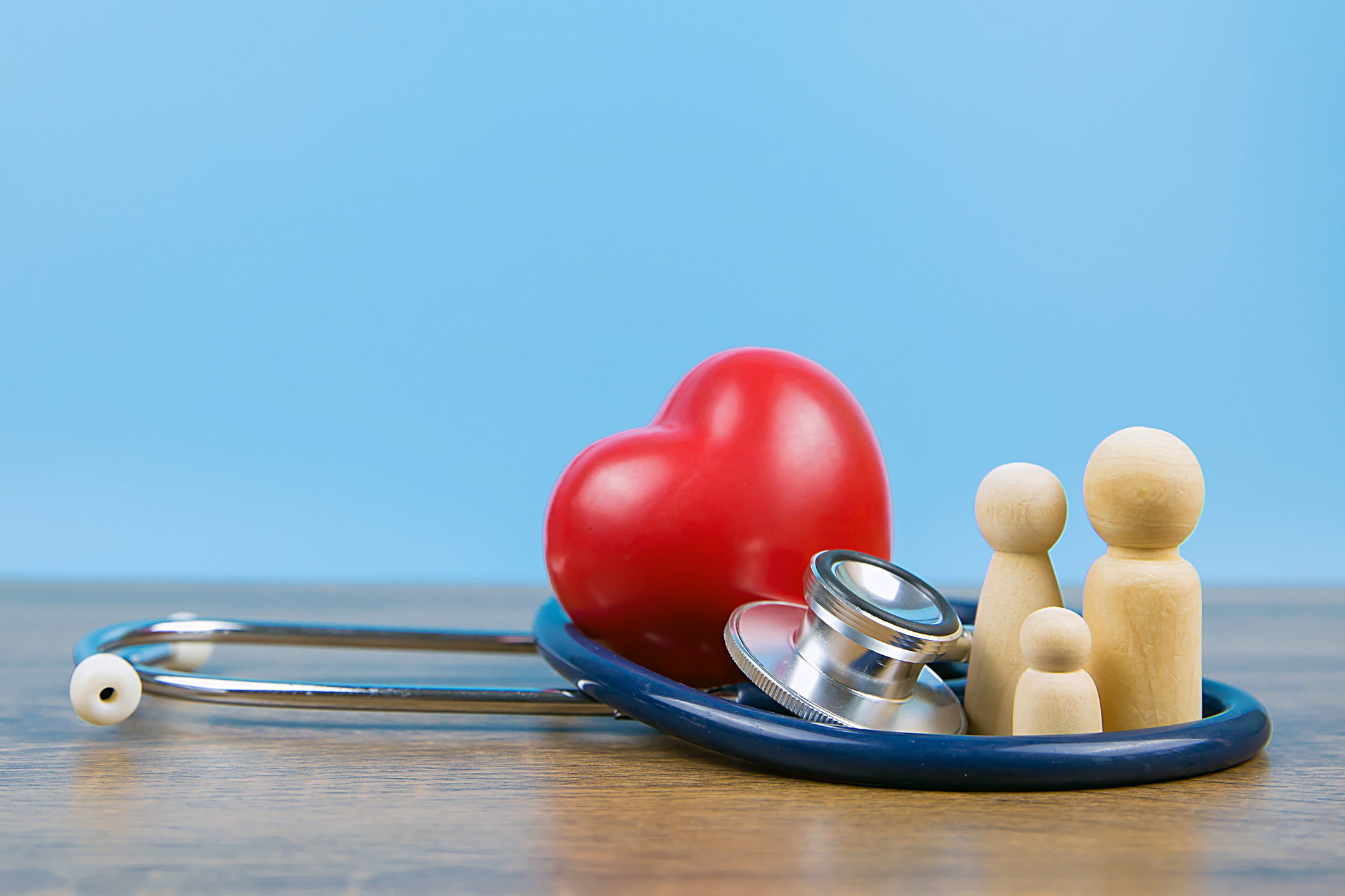 Wooden family with stethoscope and a red heart