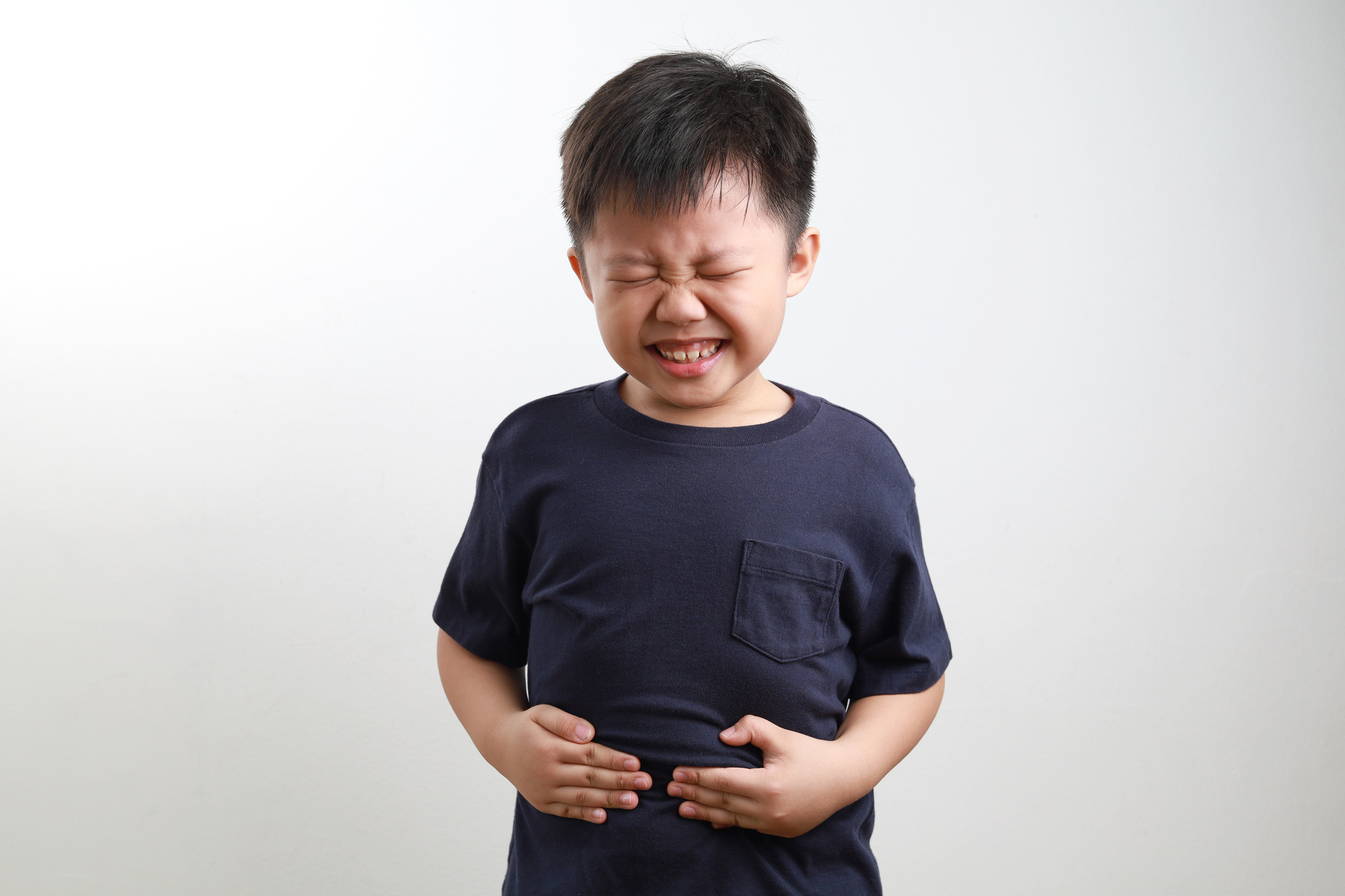 Boy holding stomach in pain