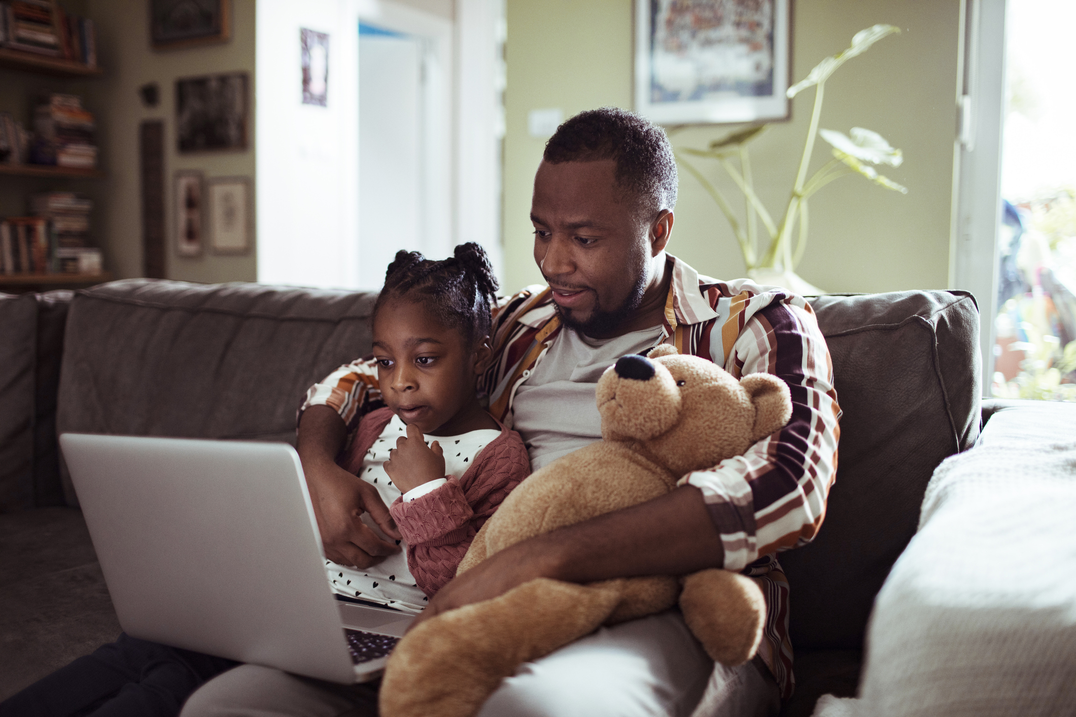 Father and daughter looking at computer