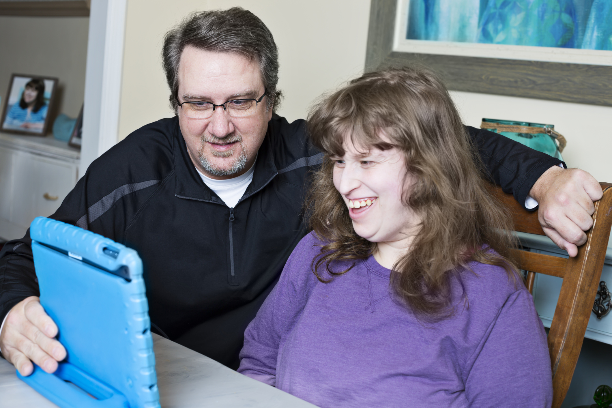 Father and daughter looking at a digital tablet