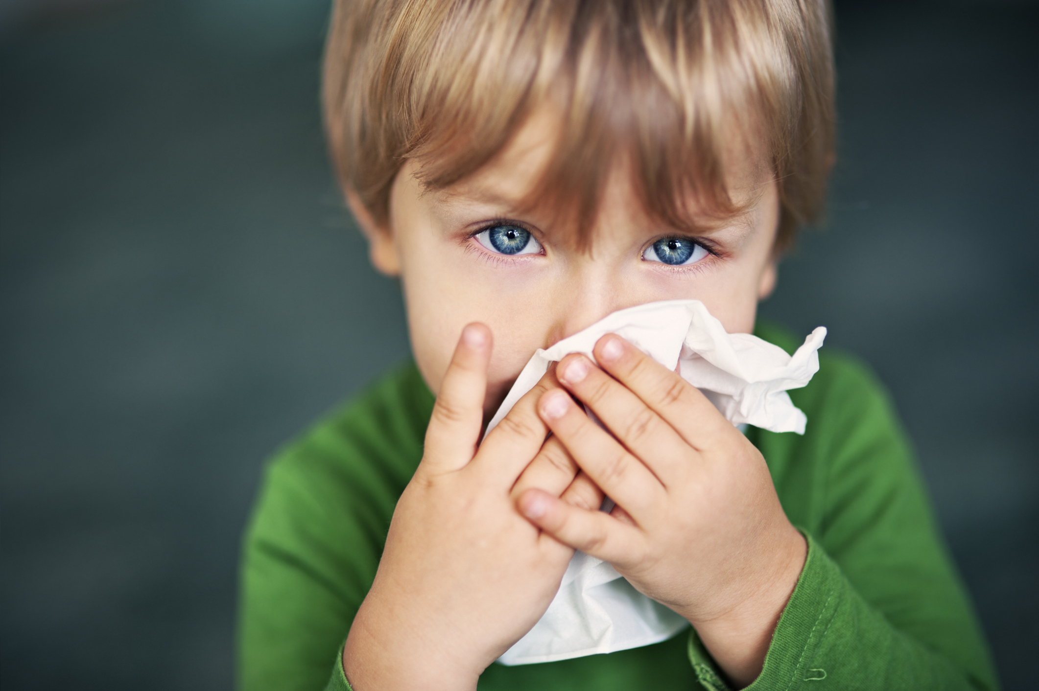 Boy blowing his nose