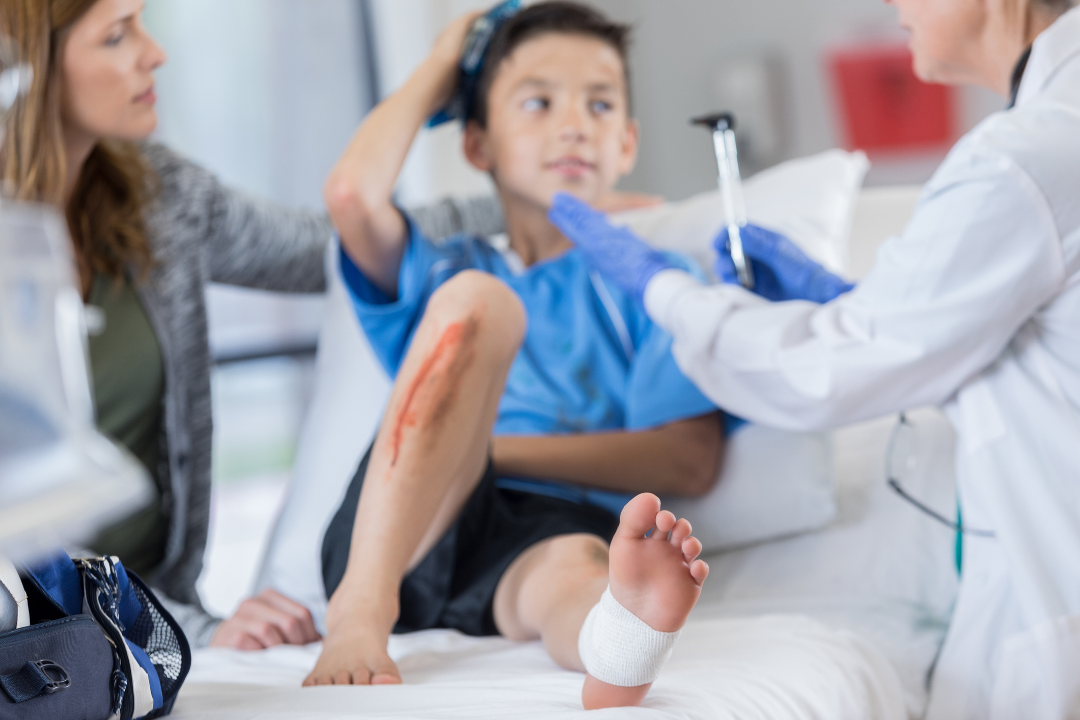 Emergency room doctor examines injured soccer player