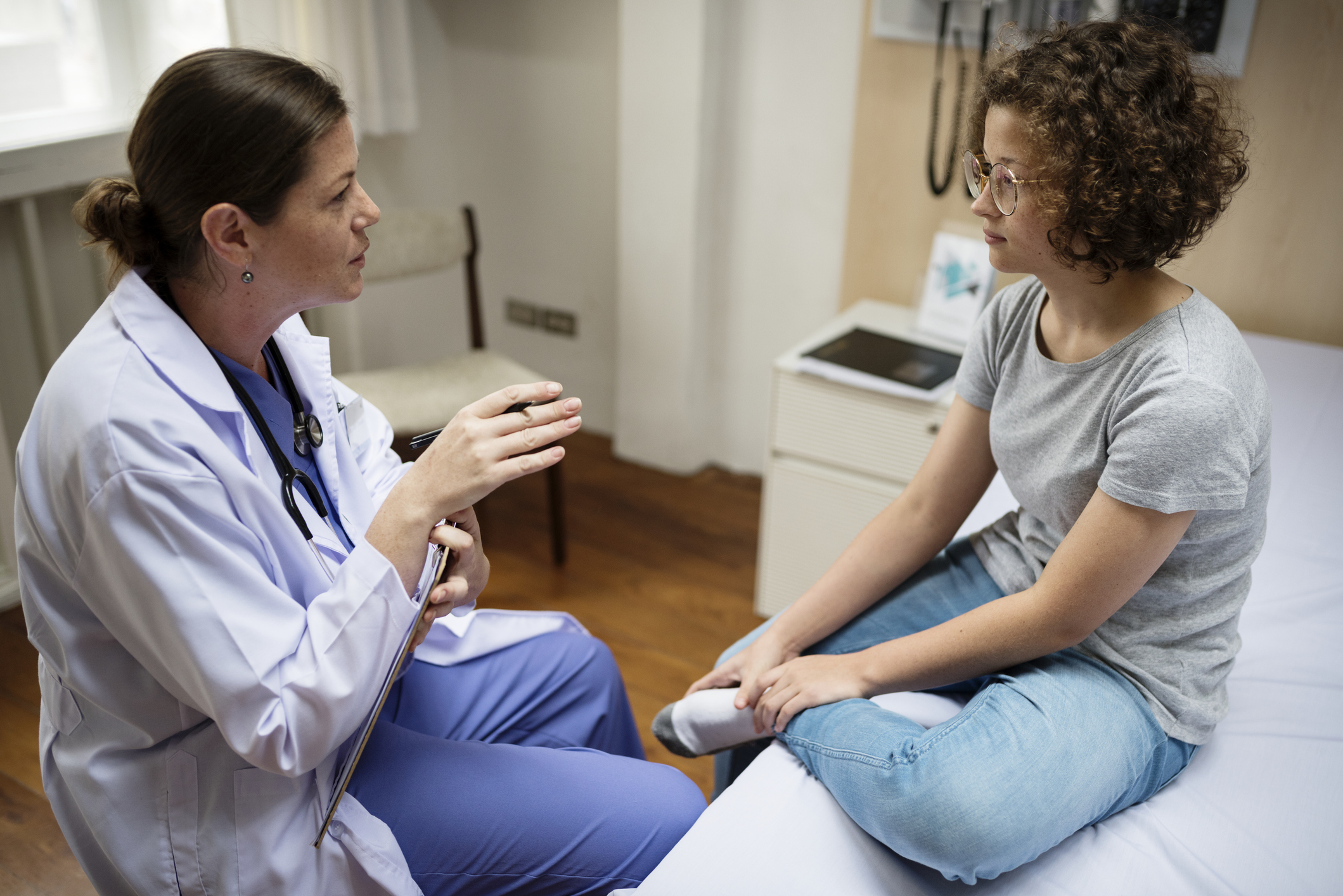 Female girl talking with female physician