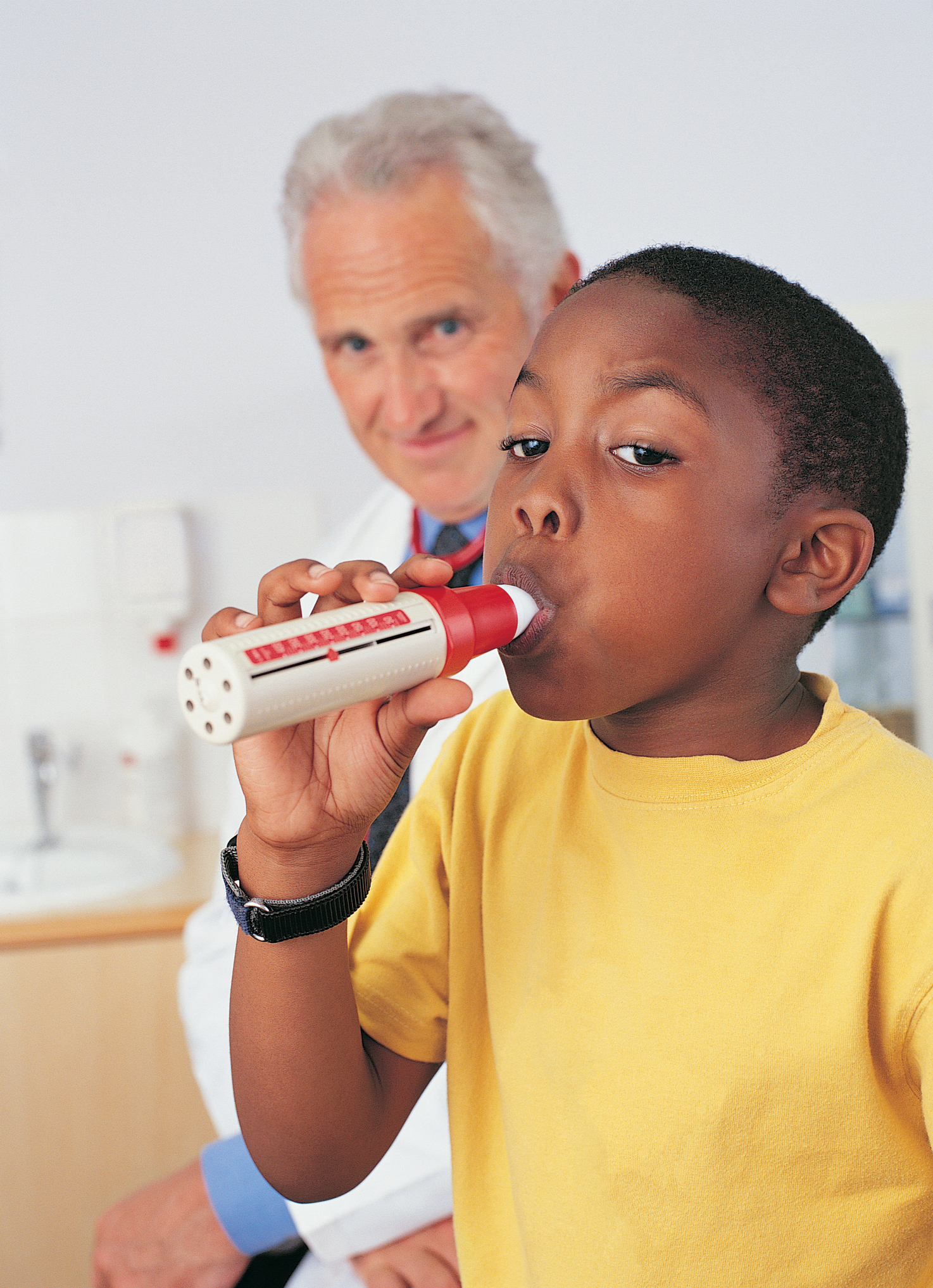 Boy breathing into a Spirometer