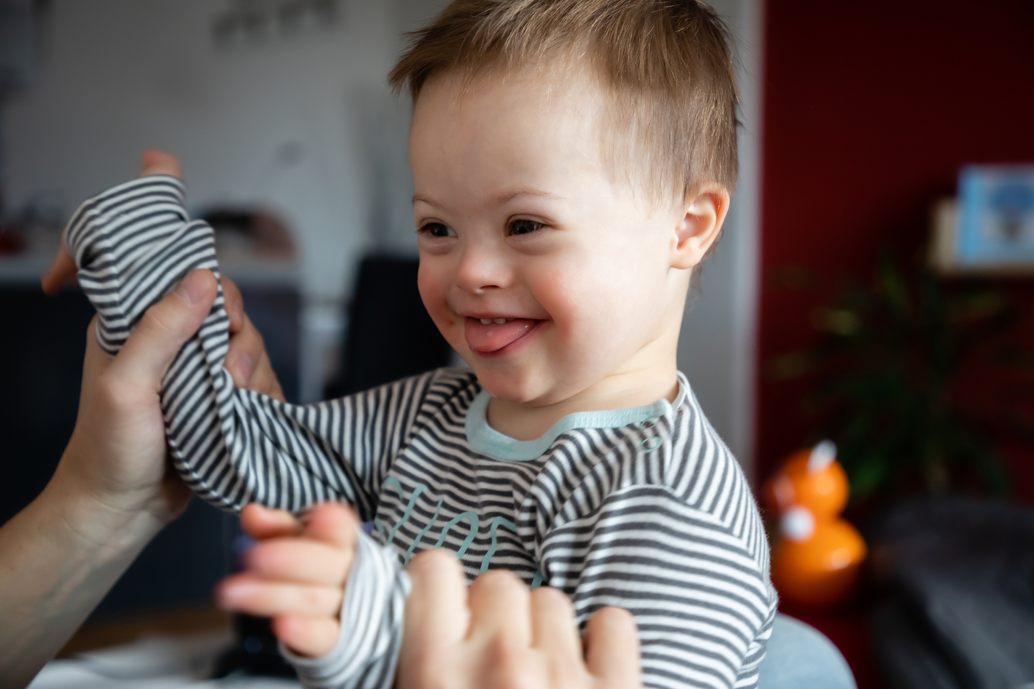 Cute boy with Down syndrome playing with dad
