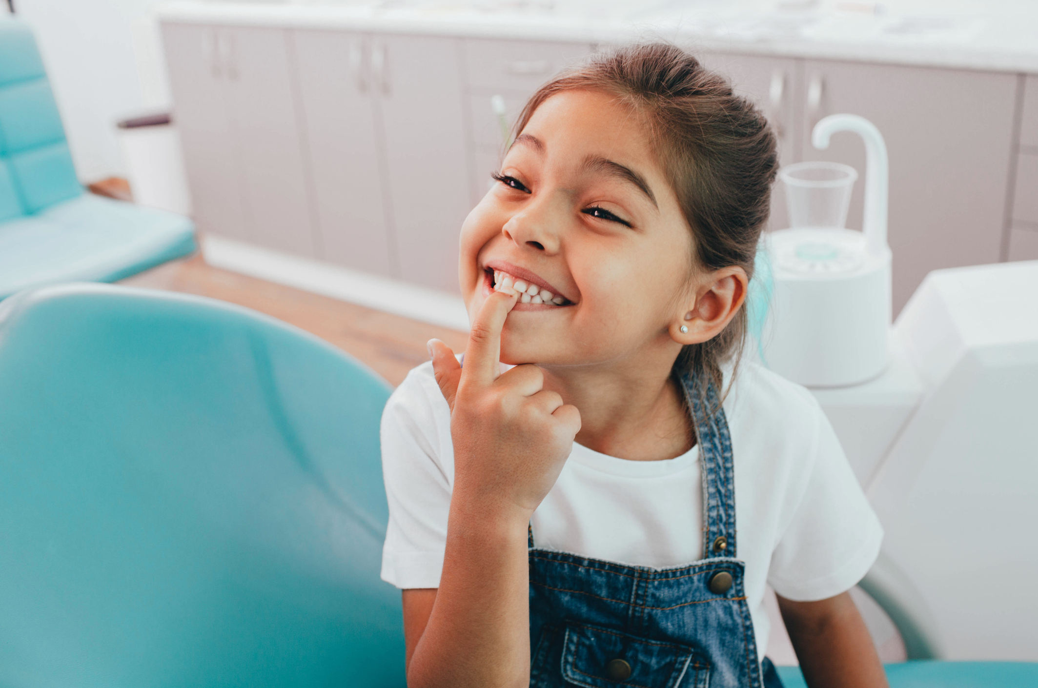 Girl pointing to tooth