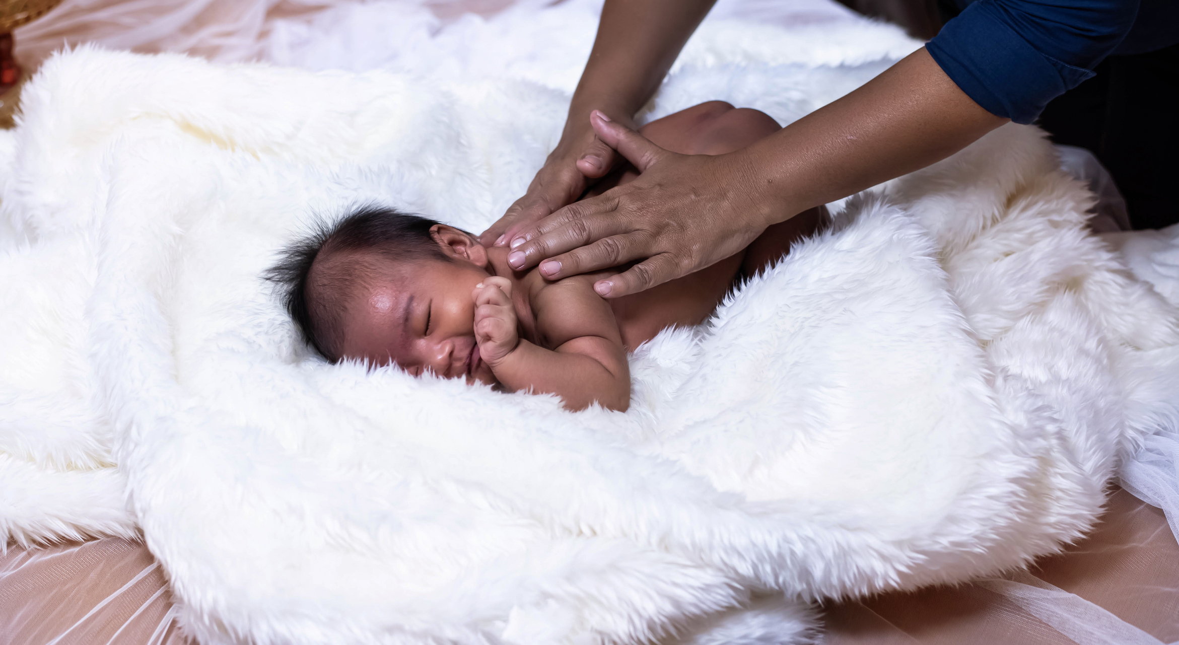 Newborn baby being massaged