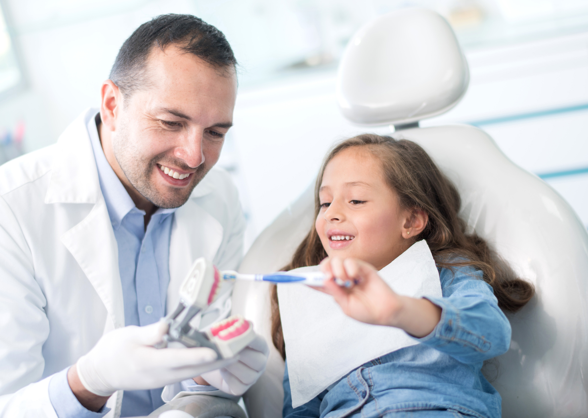 Dentist with young girl patient