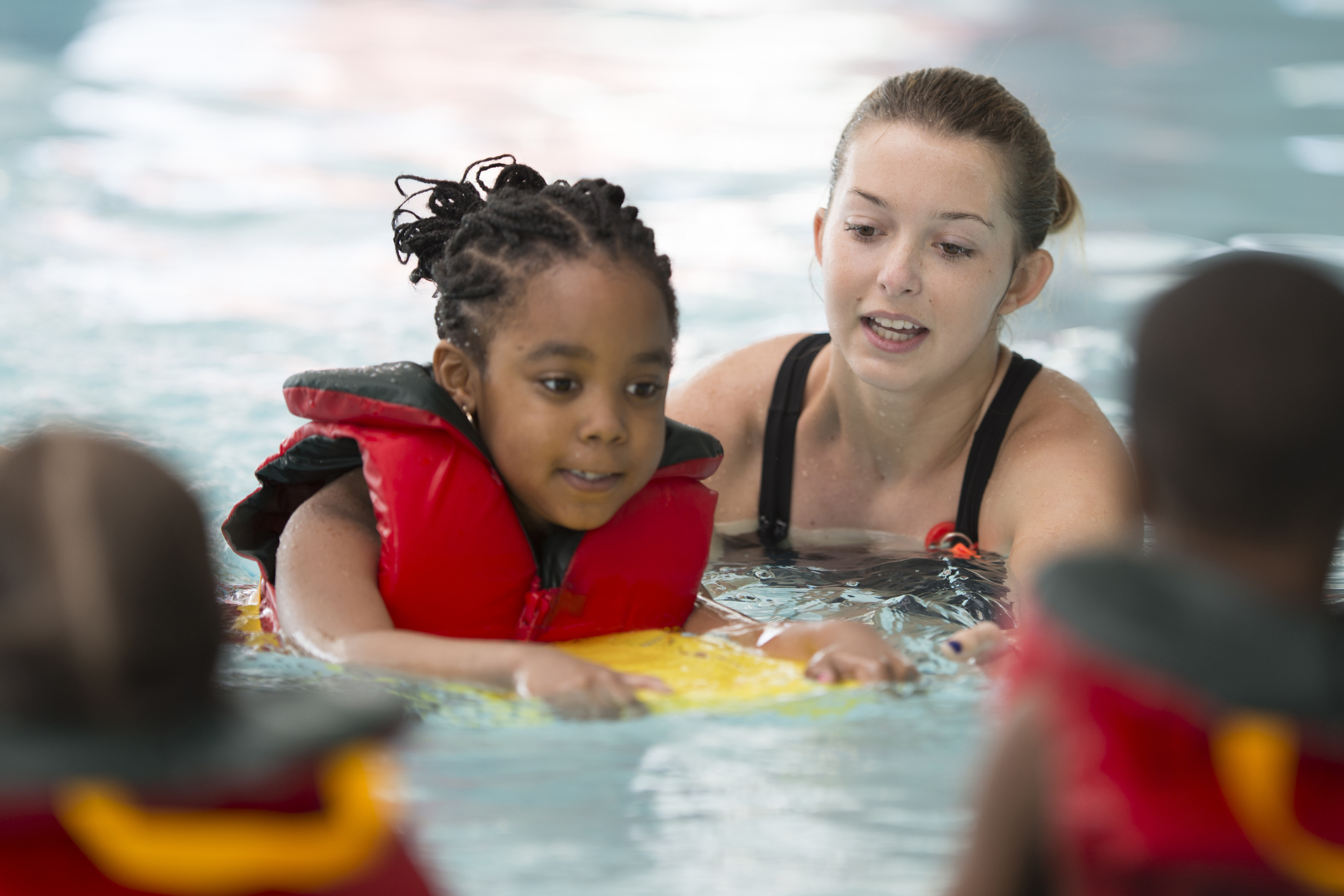 Instructor Working with a Little Girl in a Pool
