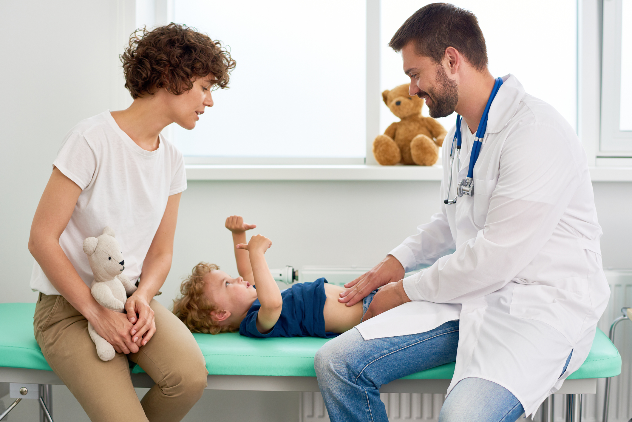 Pediatrician Palpating Stomach of Little Boy