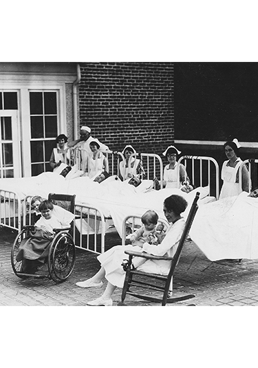 Picture from 1945 of patients outside roof area patio