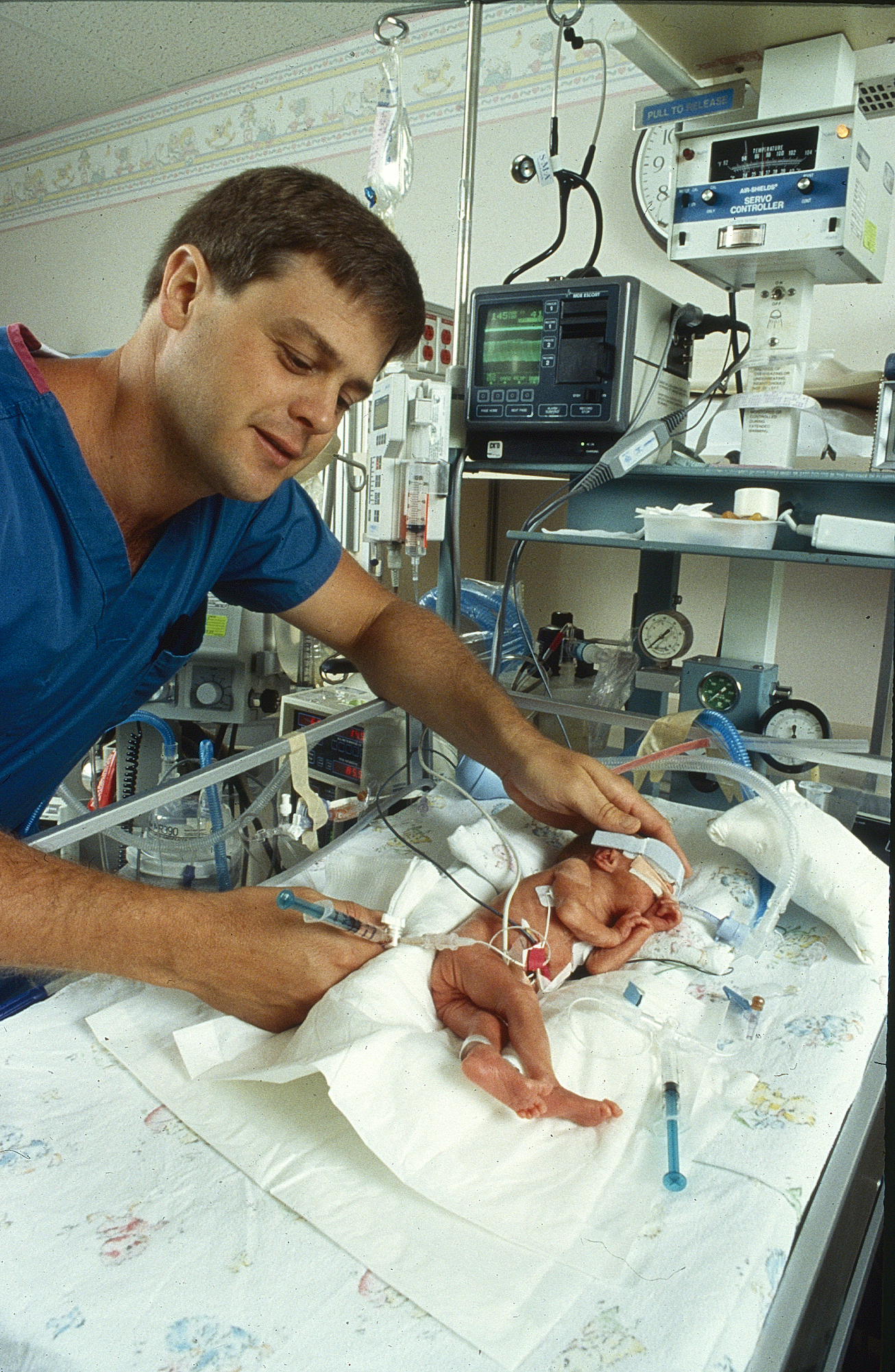 Doctor examining baby in the NICU