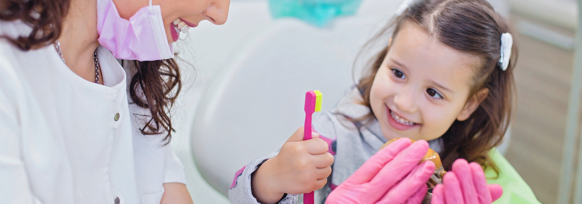 Provider giving young girl a toothbrush