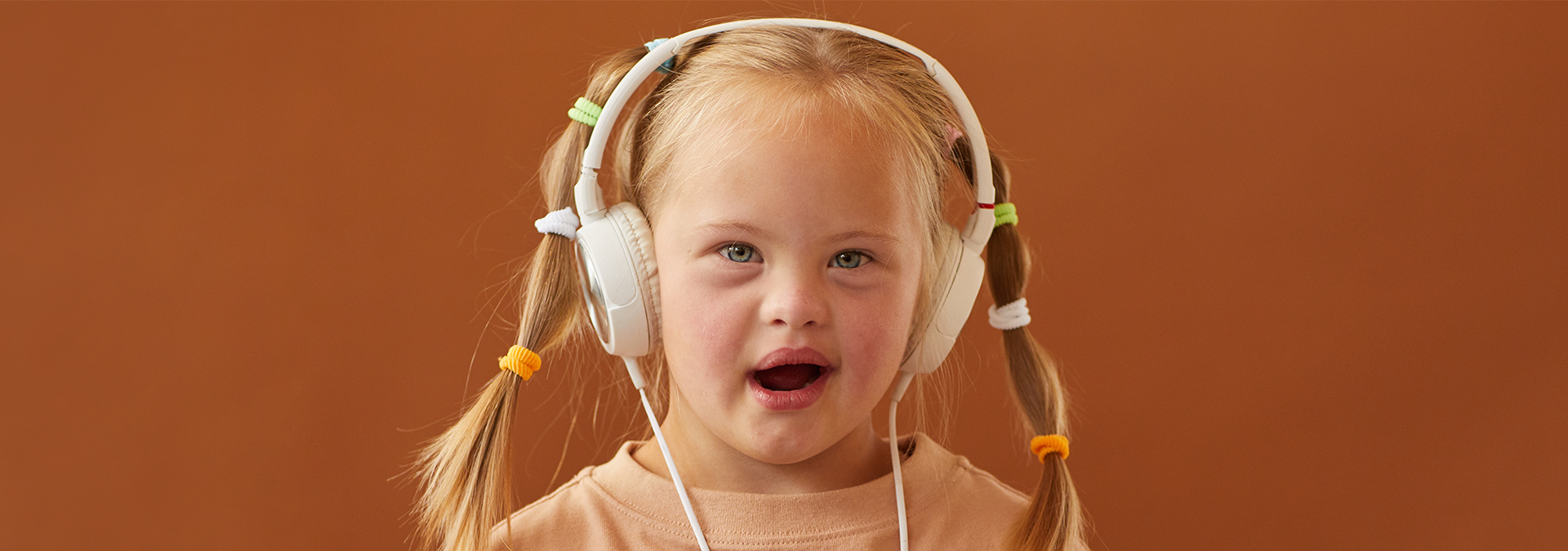 Girl with Down Syndrome listening with headphones