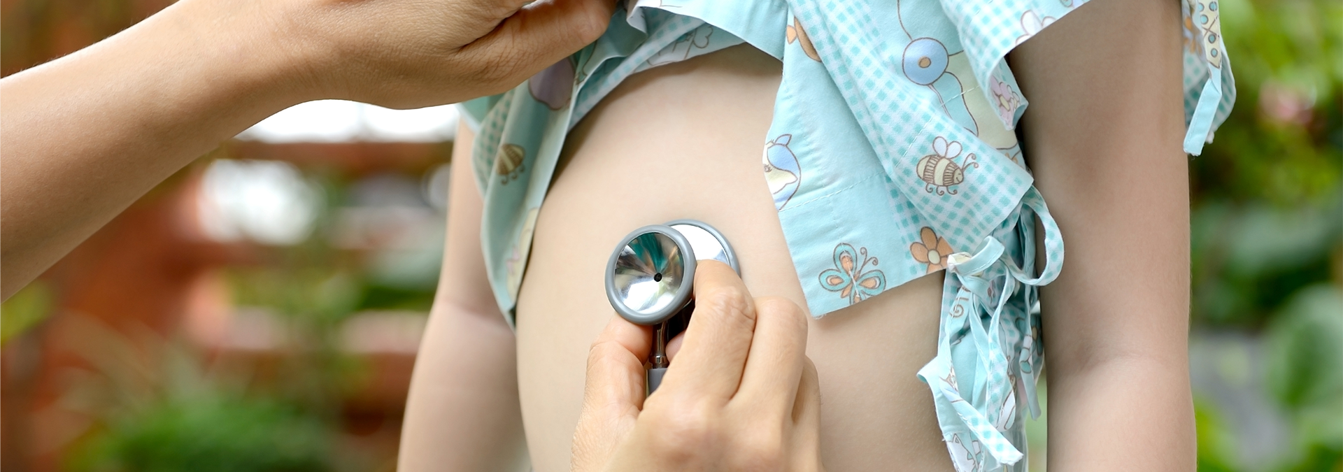 Provider with stethoscope on young child's stomach