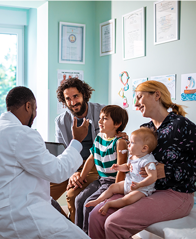 Male doctor with family in pediatrician office