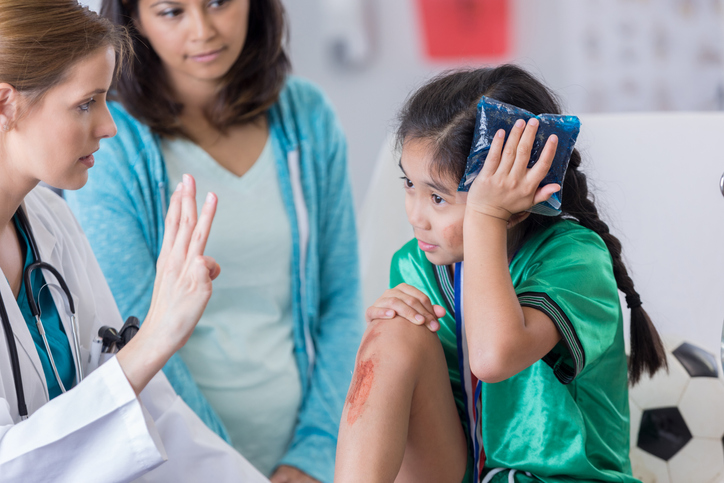 a doctor checking a patient for a concussion