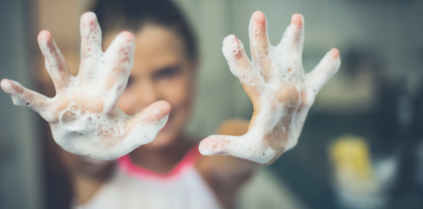 a child washing her hands