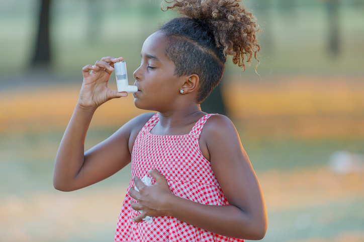 a girl using an inhaler