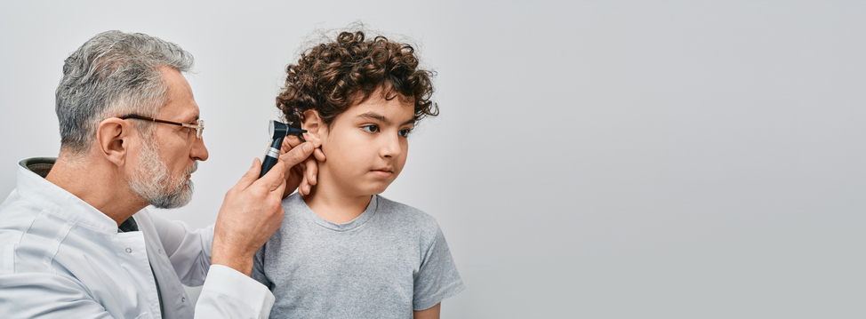 a boy getting his ear checked