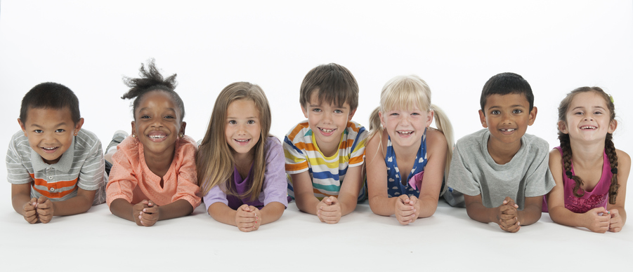 seven children in a line smiling