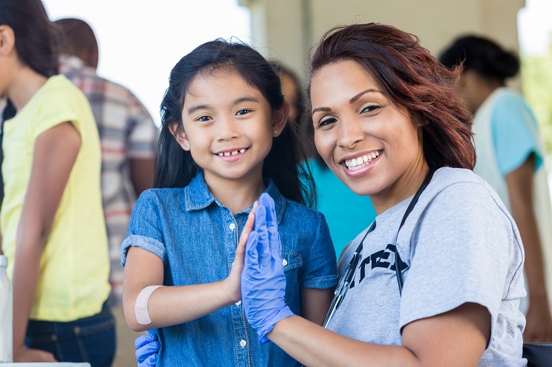 stock image of community nurse and child smiling  