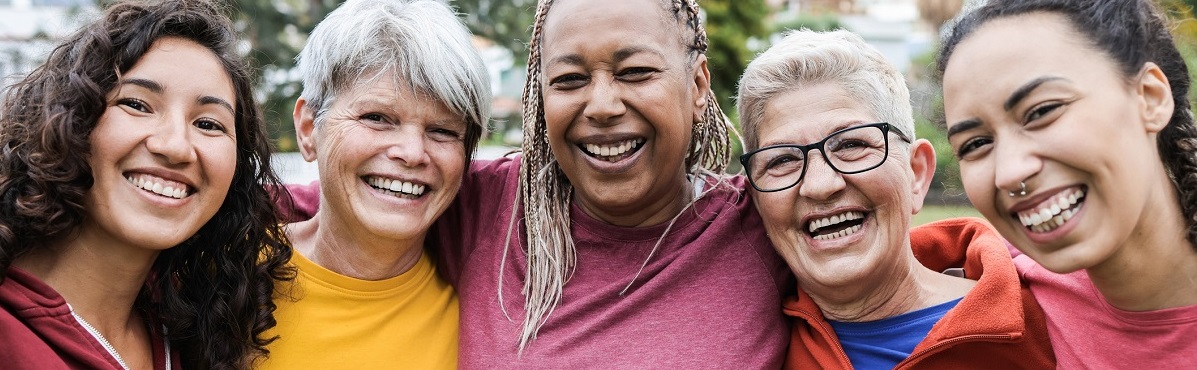 closeup of diverse group of active women smiling together outside
