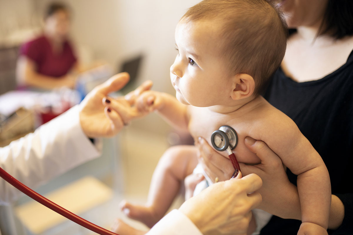 Doctor listening to baby's heart