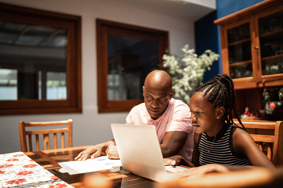 Father and daughter looking online