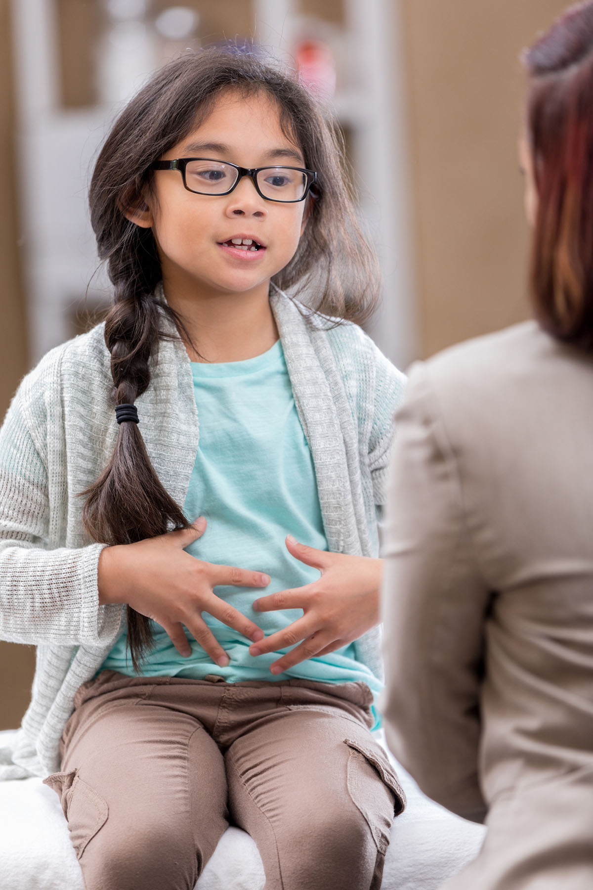 Young girl holding stomach