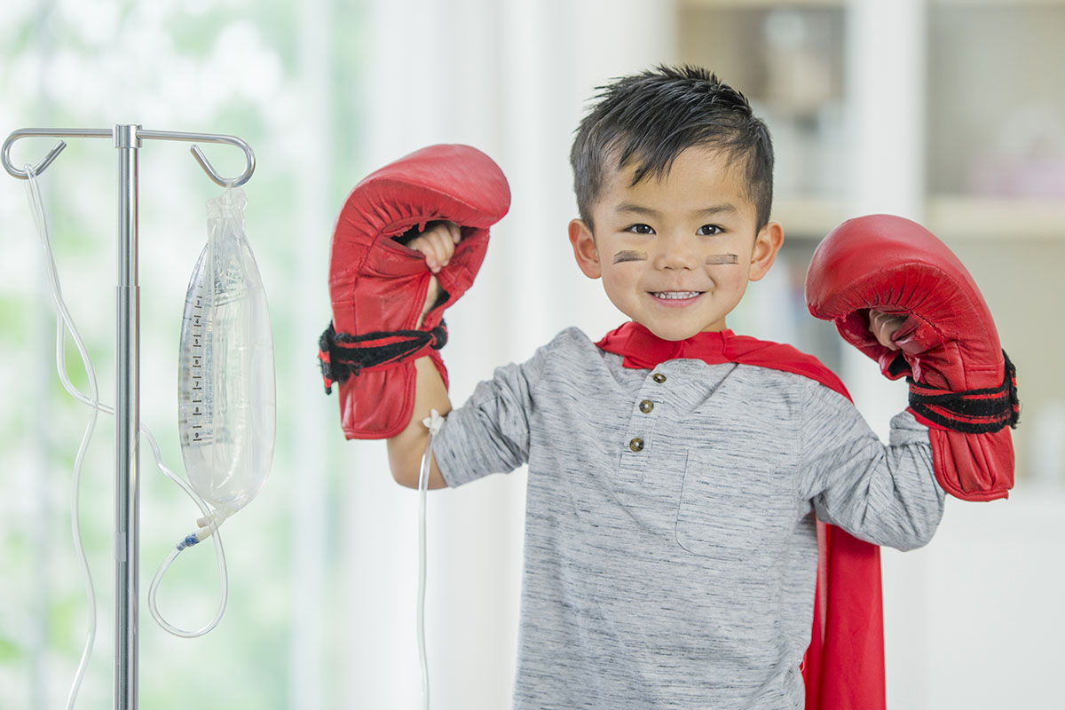 Boy with boxing gloves and cape