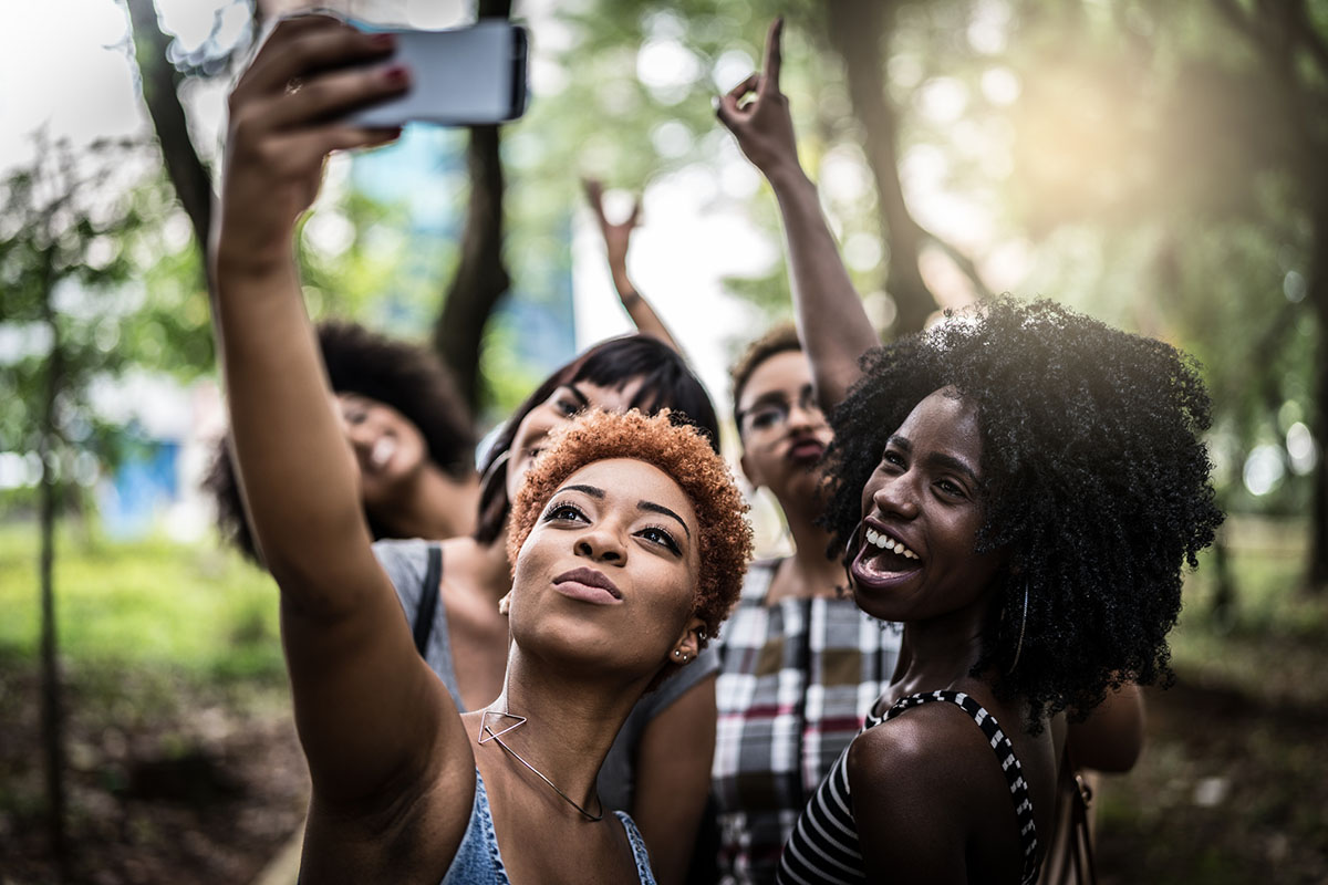 Multiracial group of girl friends taking selfie