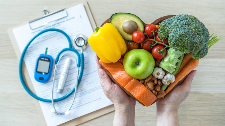 Healthy food with stethoscope and insulin monitor
