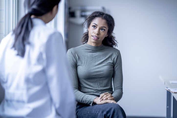 Woman listening to health professional explain something 
