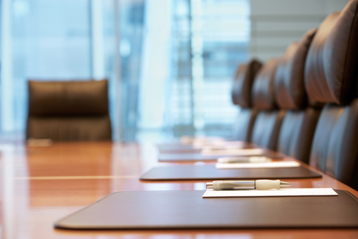 empty board room with place settings in front of chairs