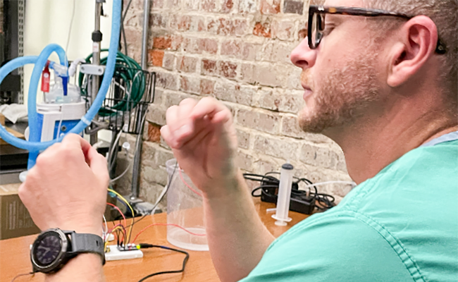 Dr. Witcher looking at prototype 