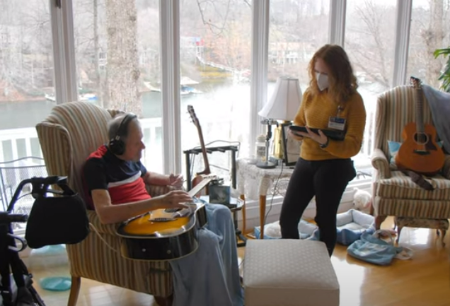 Hospice music therapist with patient