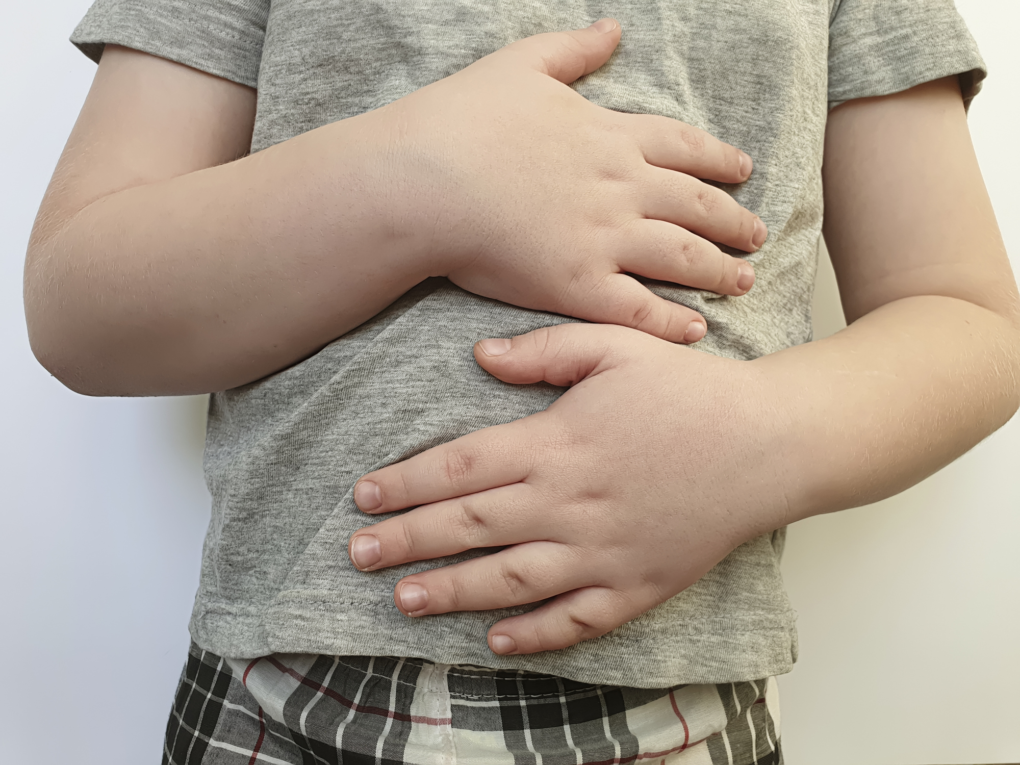 child holding abdomen