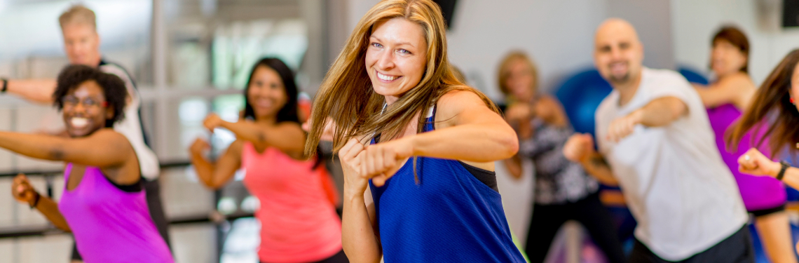 A group exercise class has fun in the gym.