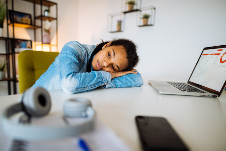 College student with her head laying on a desk