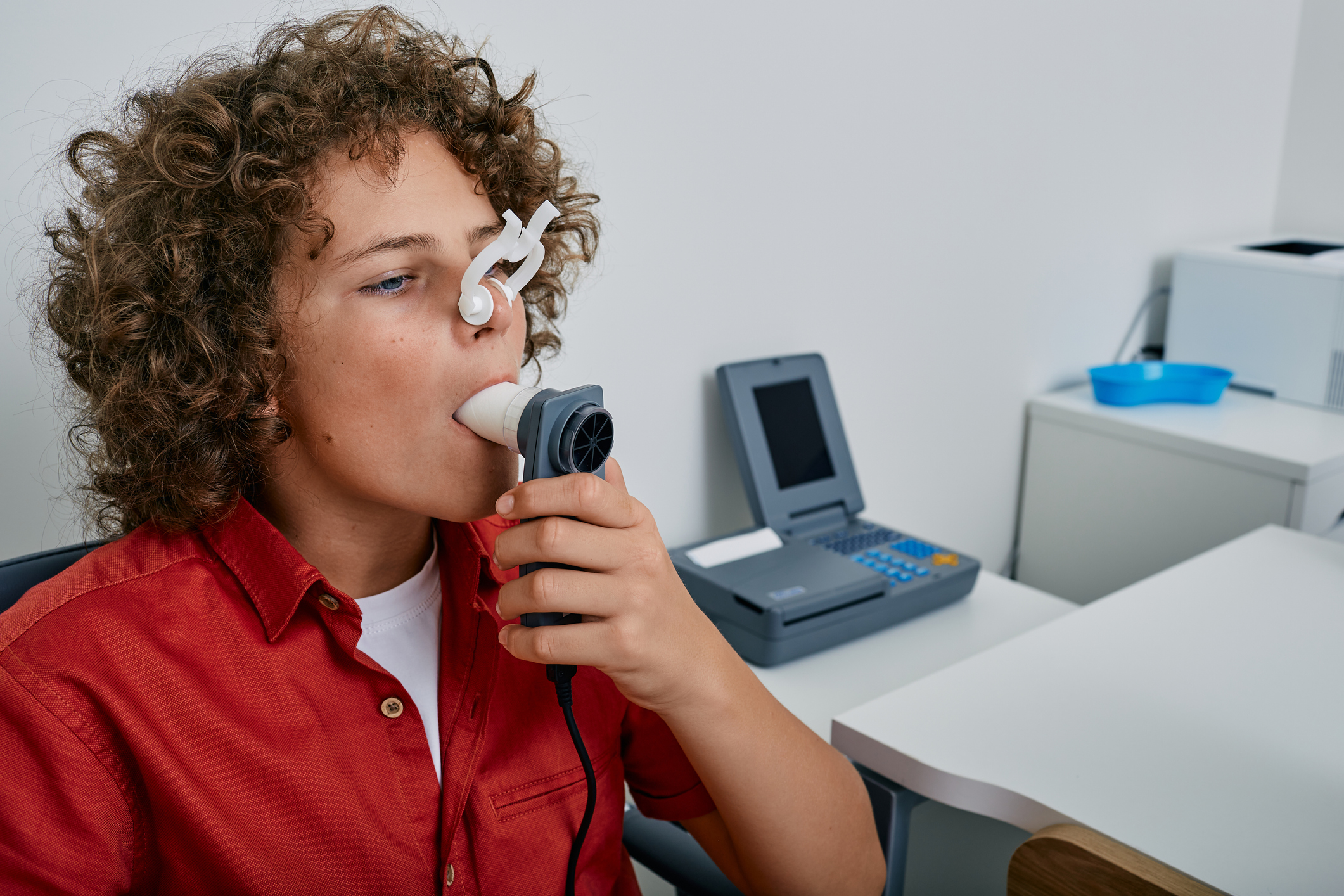 Boy breathing into a Spirometer