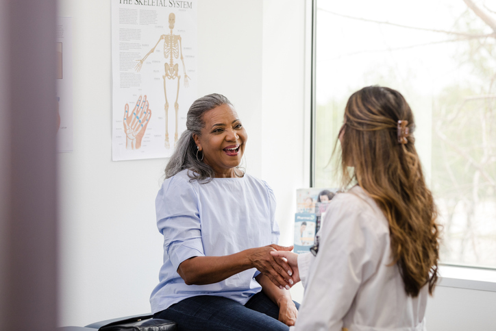 Older woman talking to female doctor