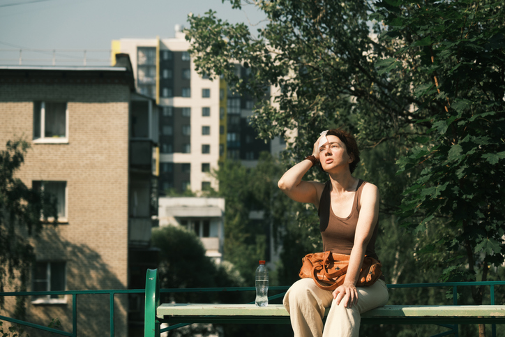 Woman sitting outside in the heat