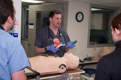 man teaching a group of medical students