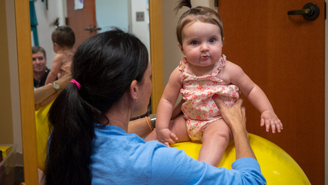 Pediatric physical therapist with young girl