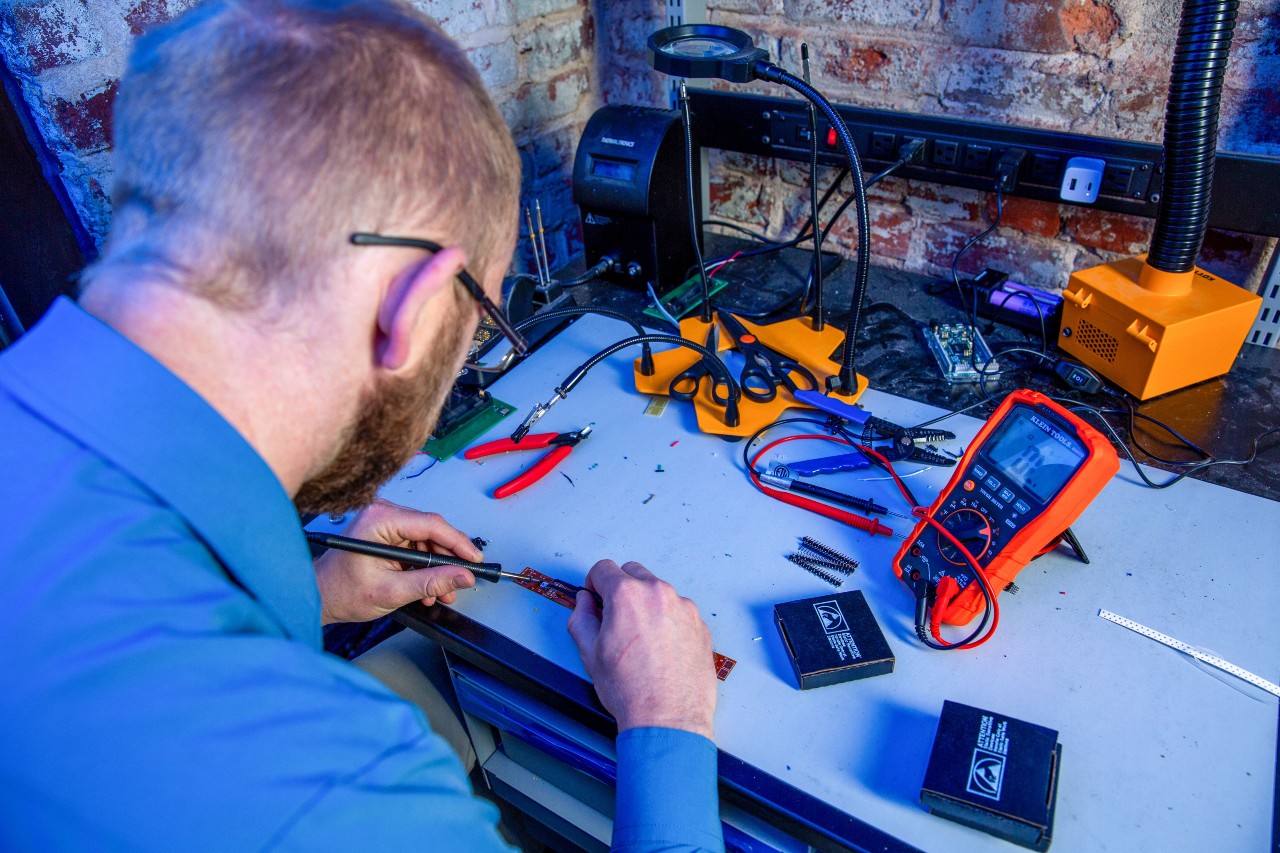 Person working at desk using tools 
