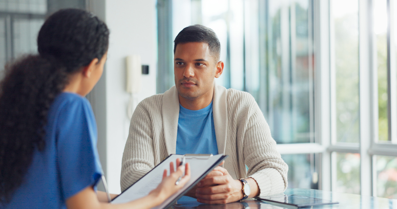 nurse talking to male patient