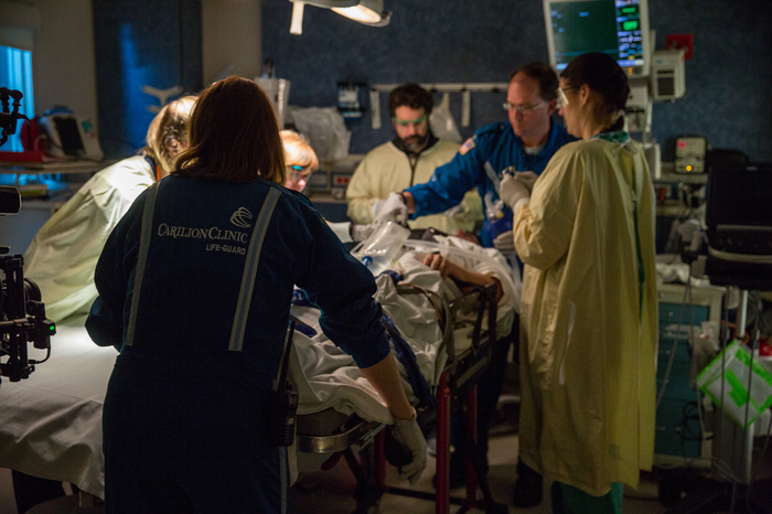 trauma patient on table with medical team around bed