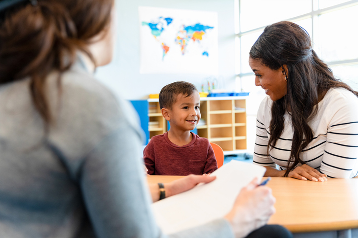 a student and parent talking with a teacher